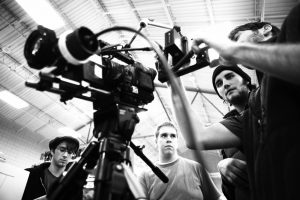 Film crew around camera.